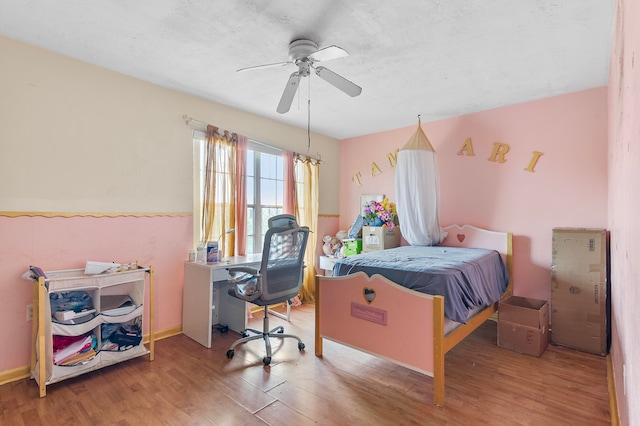 bedroom with wood-type flooring and ceiling fan