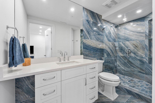 bathroom featuring vanity, toilet, walk in shower, and tile walls