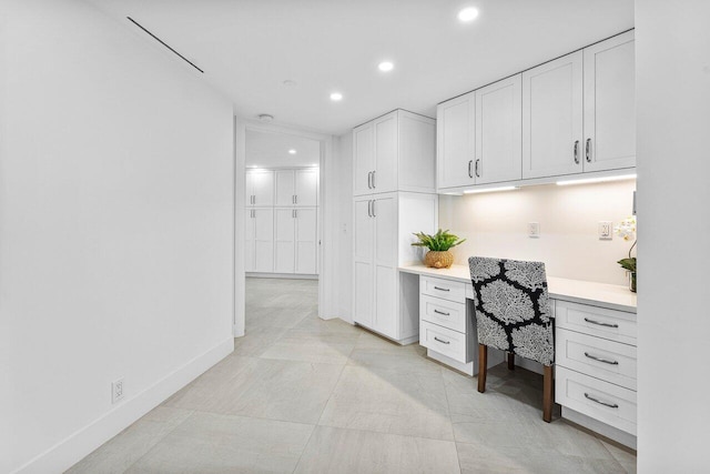 office area featuring built in desk and light tile patterned floors