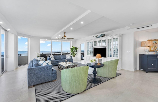 living room featuring a water view and ceiling fan