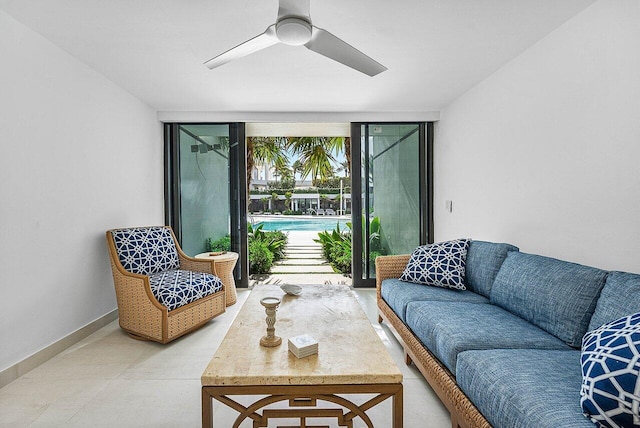 living room with expansive windows and ceiling fan