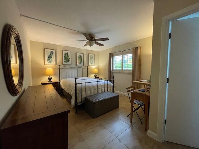 tiled bedroom with ceiling fan