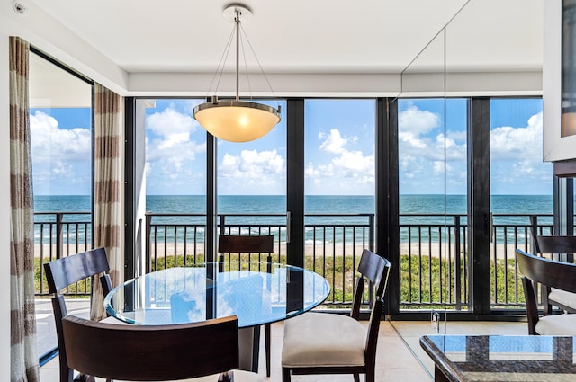 sunroom / solarium with a water view and a healthy amount of sunlight