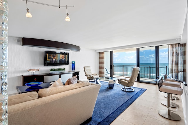 living room with expansive windows and light tile patterned floors