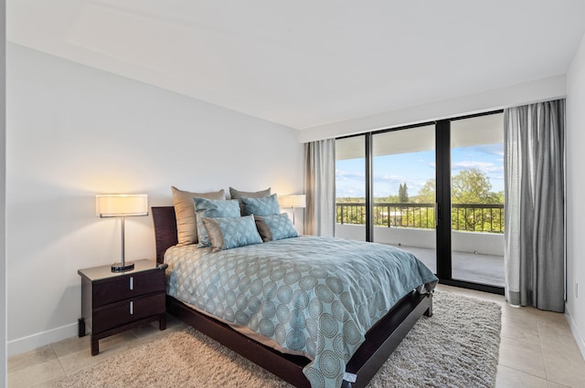 bedroom with access to exterior and light tile patterned floors