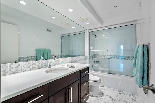 full bathroom featuring tasteful backsplash, combined bath / shower with glass door, tile walls, toilet, and vanity