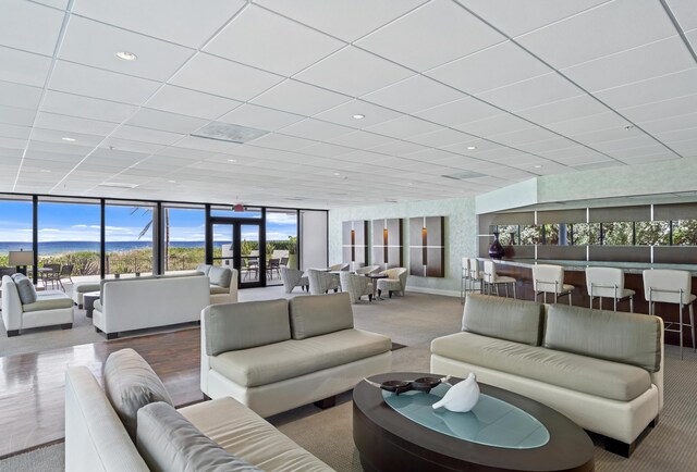 1800 S Ocean Blvd Unit 5C, Boca Raton, FL 33432 - carpeted living room featuring a drop ceiling and floor to ceiling windows