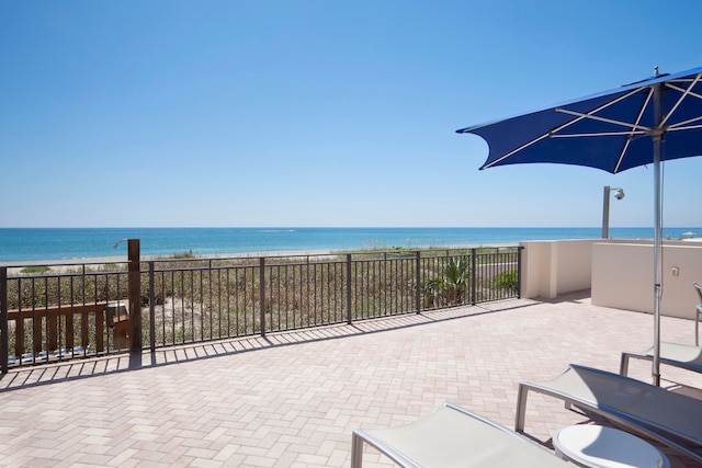 view of patio with a water view