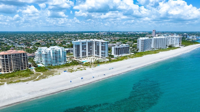 drone / aerial view featuring a view of the beach and a water view