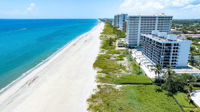 bird's eye view featuring a water view and a beach view