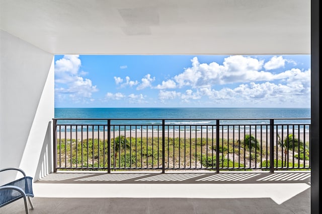 balcony with a water view and a beach view