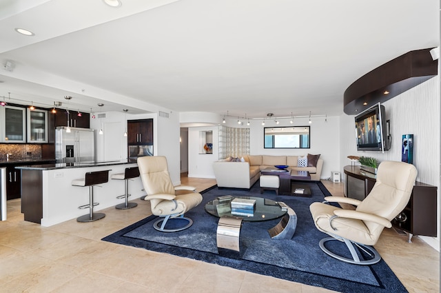 living room with track lighting and light tile patterned floors