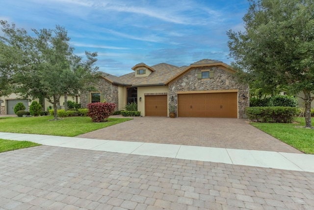 view of front of property with a front yard and a garage