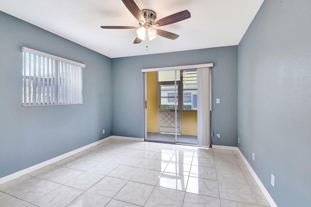 tiled spare room with ceiling fan