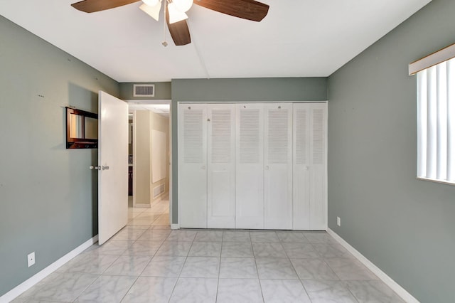 unfurnished bedroom with a closet and ceiling fan