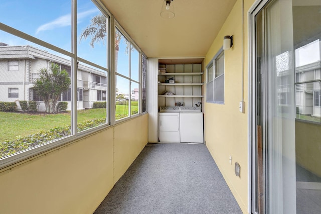 unfurnished sunroom featuring washing machine and clothes dryer