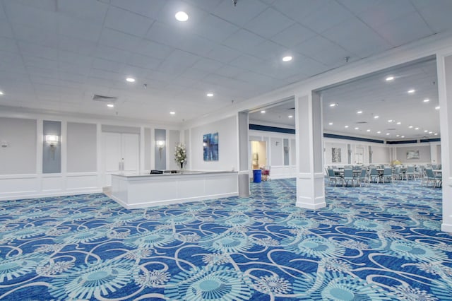 interior space with crown molding and carpet floors