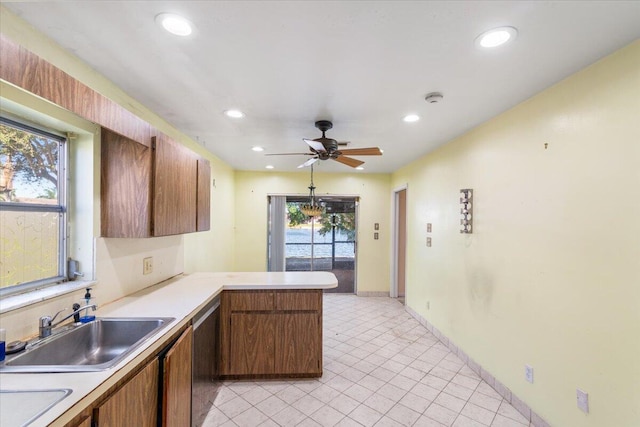 kitchen featuring kitchen peninsula, ceiling fan, dishwasher, and sink