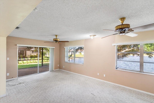 spare room with light carpet and a textured ceiling