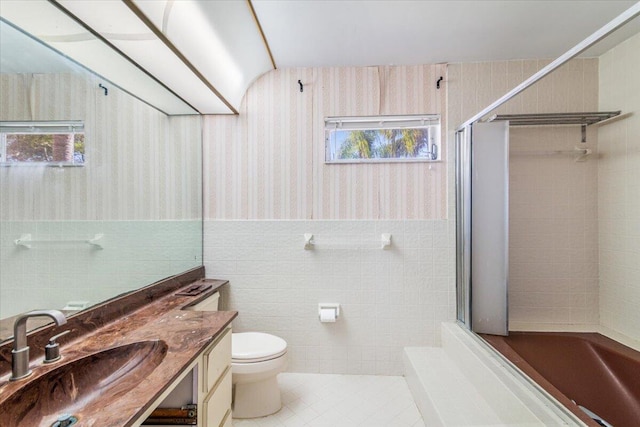 bathroom featuring walk in shower, tile patterned flooring, a wealth of natural light, and tile walls