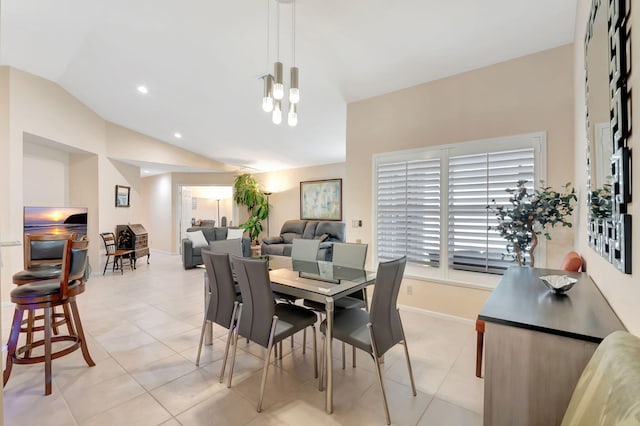 tiled dining room with lofted ceiling and a notable chandelier