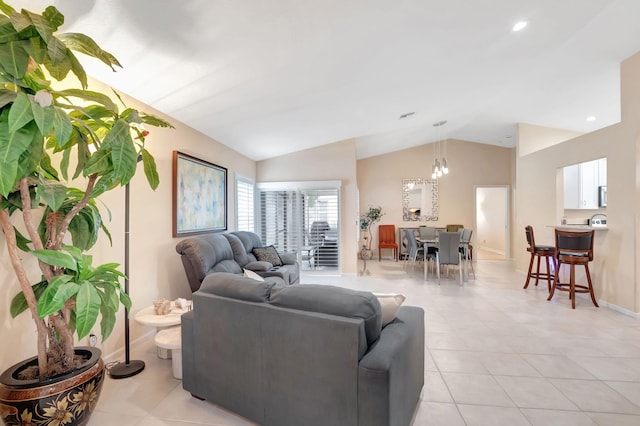 living room featuring a chandelier, light tile patterned floors, and vaulted ceiling