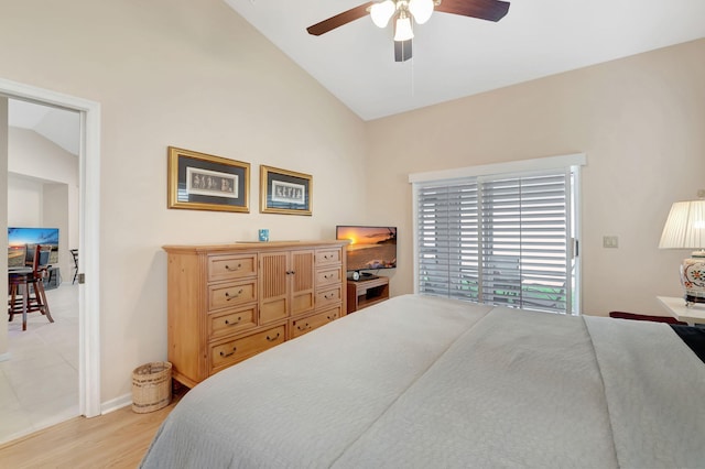 bedroom featuring ceiling fan, light wood-type flooring, and lofted ceiling