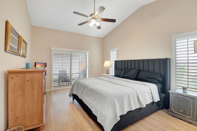 bedroom with ceiling fan, light hardwood / wood-style floors, and vaulted ceiling