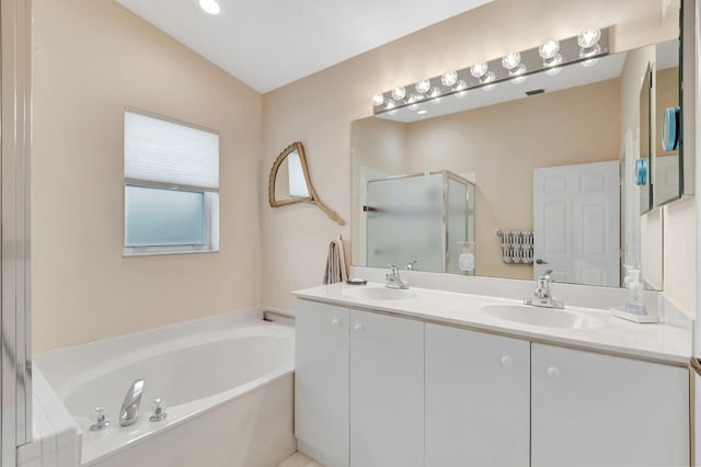 bathroom featuring vanity, independent shower and bath, and vaulted ceiling