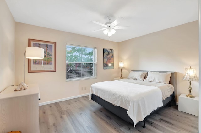 bedroom with ceiling fan and light wood-type flooring