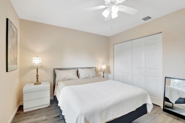 bedroom featuring light hardwood / wood-style flooring, a closet, and ceiling fan