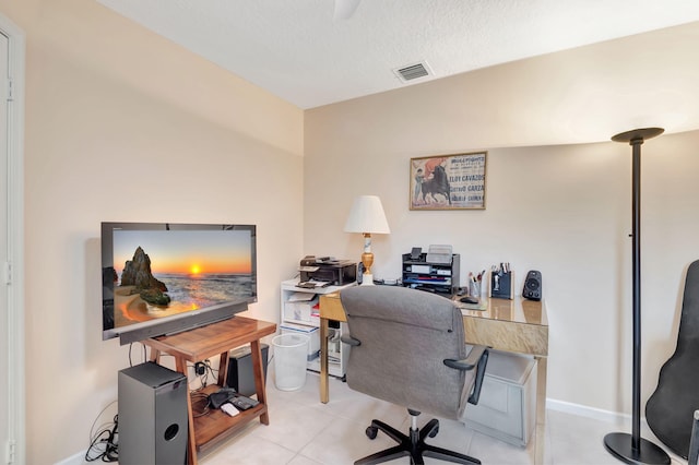 office space featuring light tile patterned floors and a textured ceiling