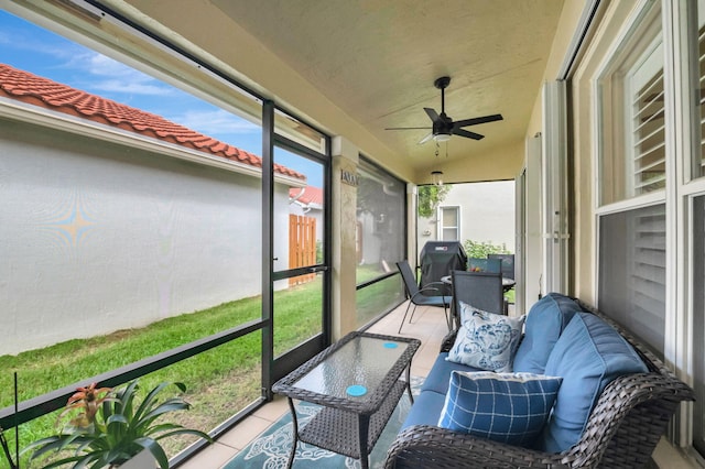 sunroom with ceiling fan and lofted ceiling