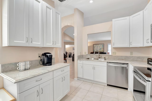 kitchen featuring white cabinetry, stainless steel appliances, light stone countertops, and sink