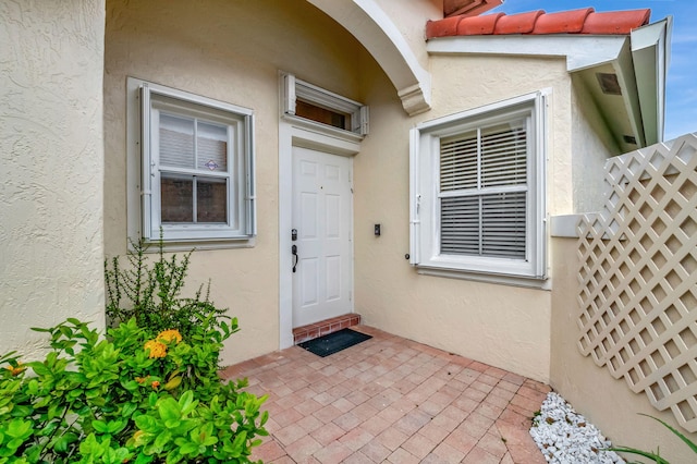 entrance to property featuring a patio area