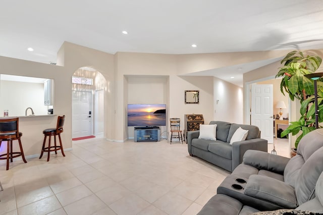 living room with sink and light tile patterned floors