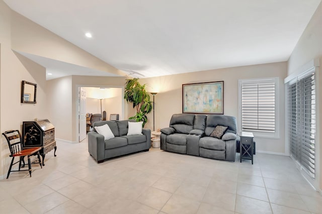 tiled living room featuring vaulted ceiling