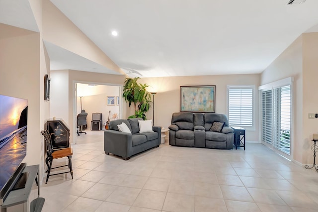 living room featuring light tile patterned floors and lofted ceiling