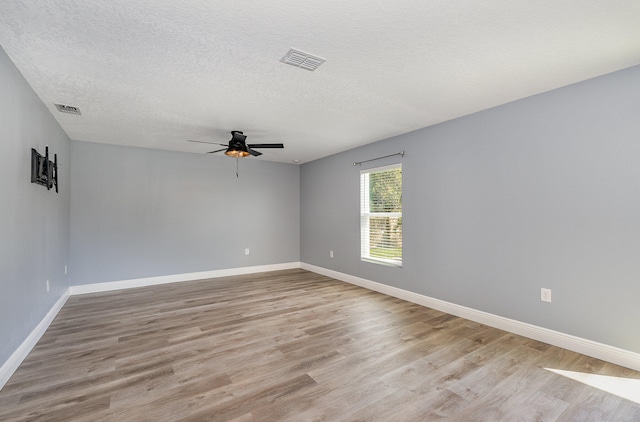 unfurnished room featuring light wood-type flooring, a textured ceiling, and ceiling fan