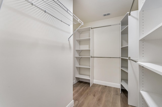 walk in closet featuring hardwood / wood-style flooring