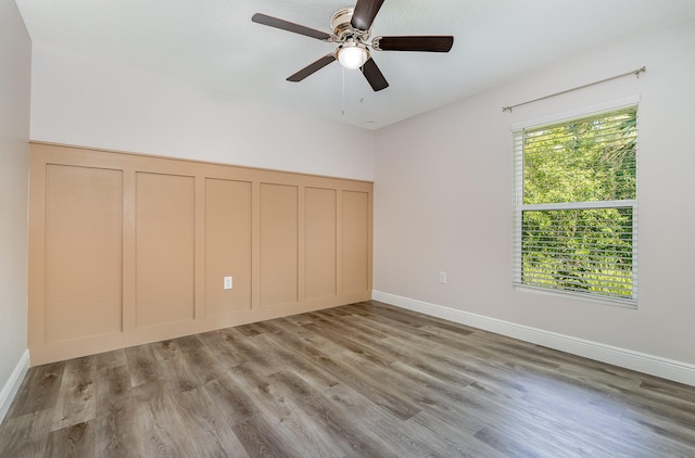 unfurnished bedroom with ceiling fan, multiple windows, and light hardwood / wood-style flooring