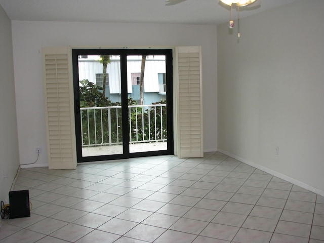 spare room with plenty of natural light, ceiling fan, and light tile patterned floors