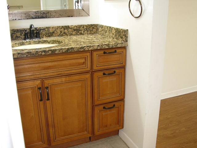 bathroom with vanity and hardwood / wood-style flooring