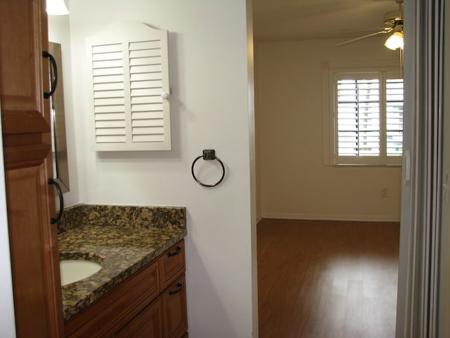 bathroom with ceiling fan, vanity, and hardwood / wood-style flooring