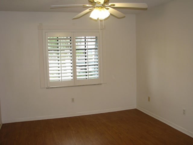 unfurnished room with ceiling fan and dark hardwood / wood-style flooring