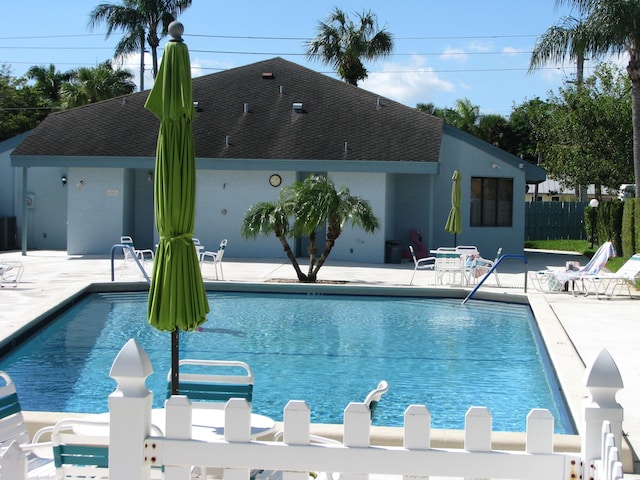 view of swimming pool featuring central AC and a patio