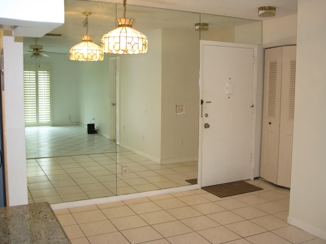 spare room with ceiling fan and light tile patterned floors