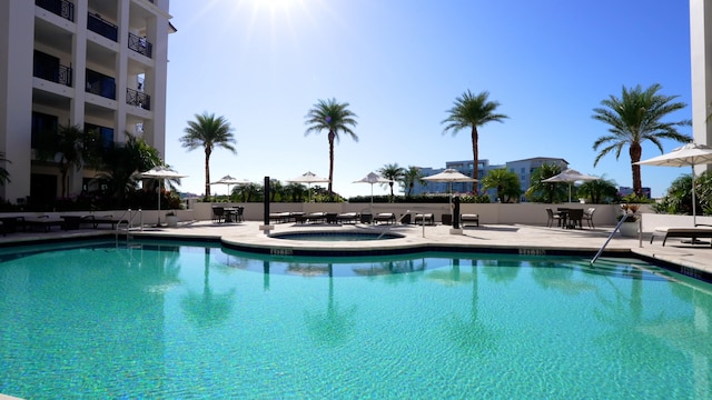 view of pool with a patio and a hot tub