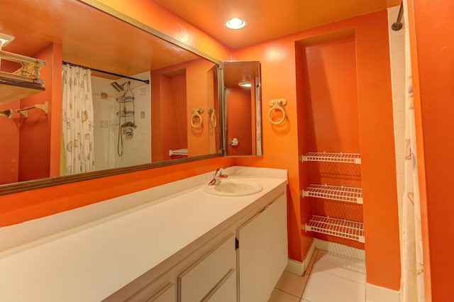 bathroom with vanity, tile patterned floors, and curtained shower