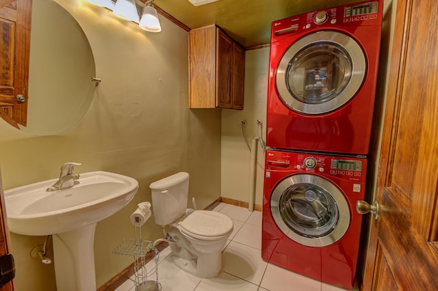 washroom featuring stacked washer / dryer and light tile patterned flooring